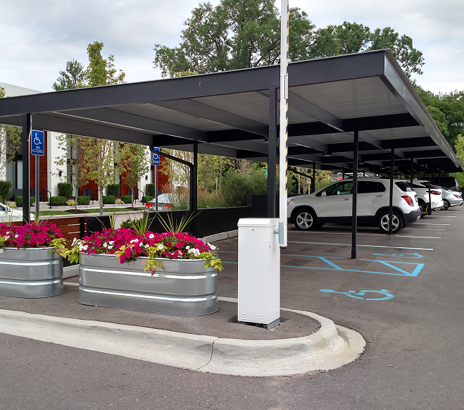 commercial carport with 2 white cars in it